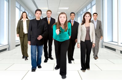 business office team going for success - all young and successful businessmen and businesswomen walking on a corridor